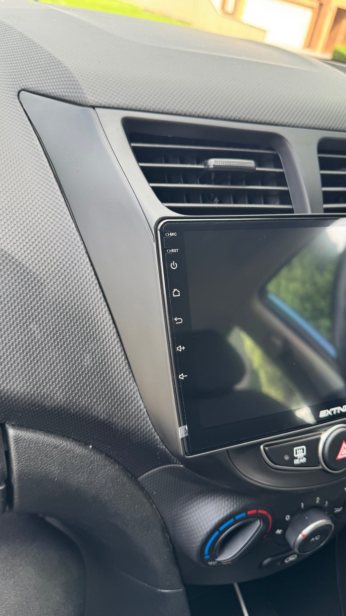 Car dashboard with a touchscreen display and air vent left side