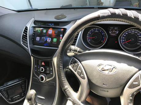 Car interior with steering wheel and dashboard showing Hyundai logo Driver view of Extnix head unit