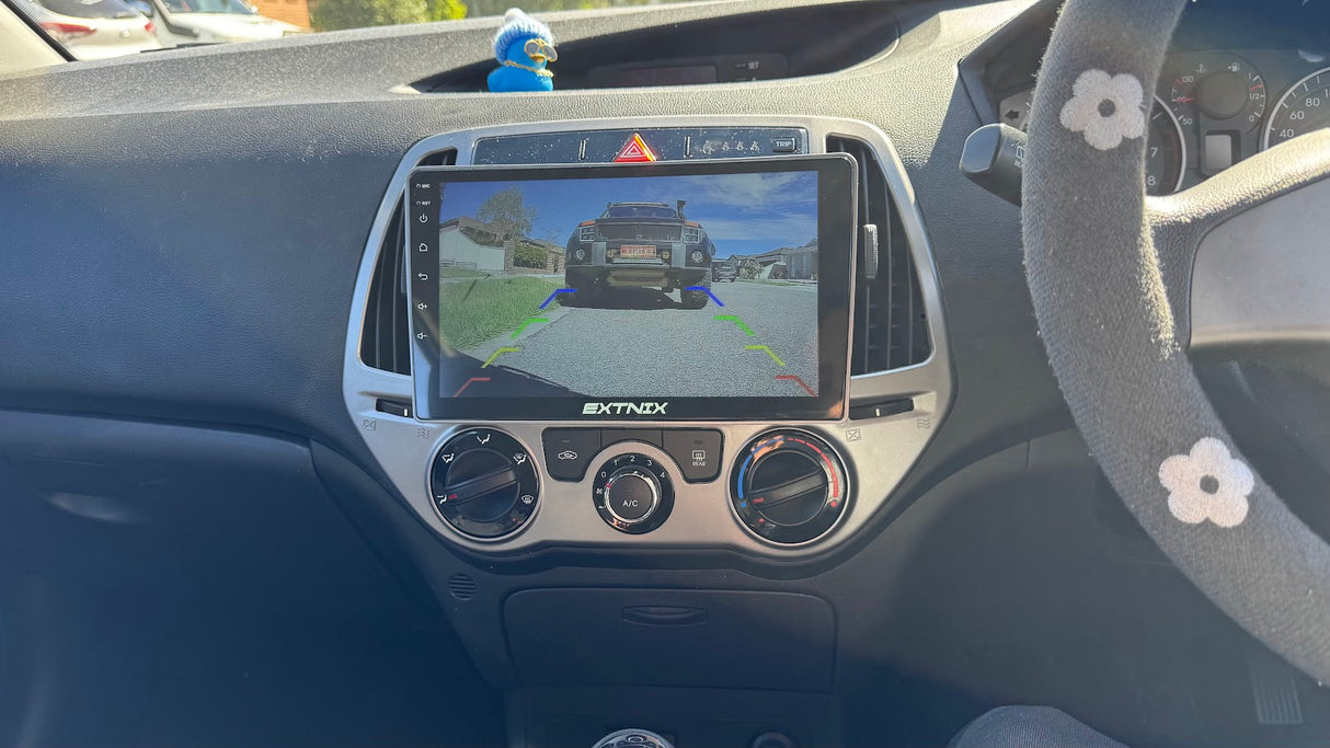 Hyundai i20 PB Car dashboard with an Extnix navigation system headunit installed and displaying AHD 720p reverse camera image of Extnix Pajero
