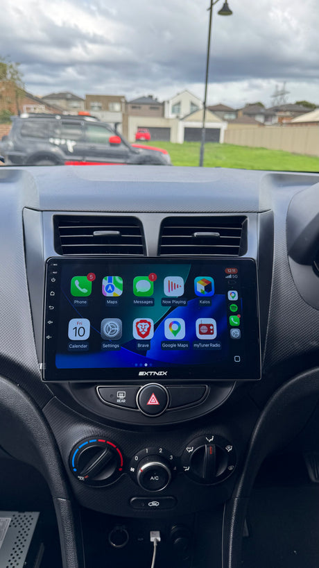Extnix Hyundai Accent Wireless Carplay headunit installed displaying various app icons.