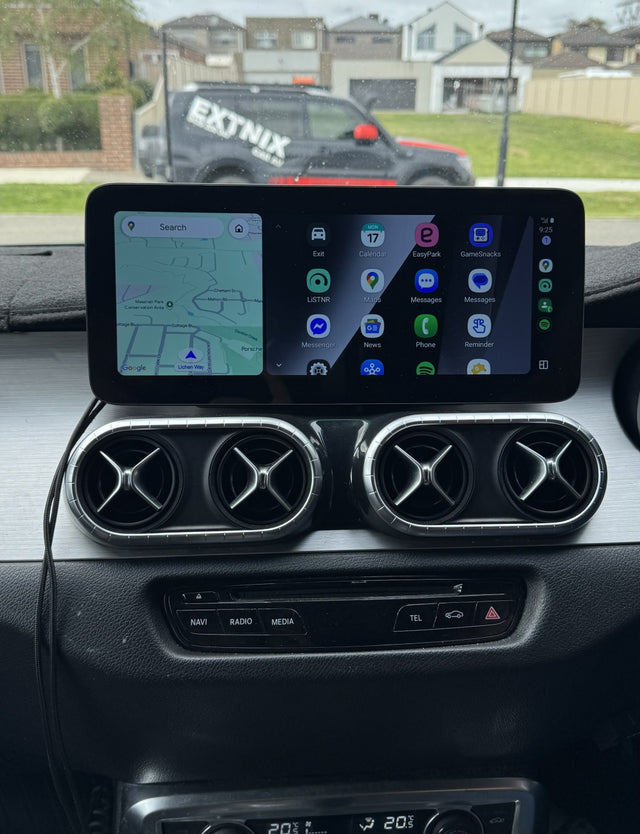 Car dashboard with a navigation system displaying a map, with a truck in the background.