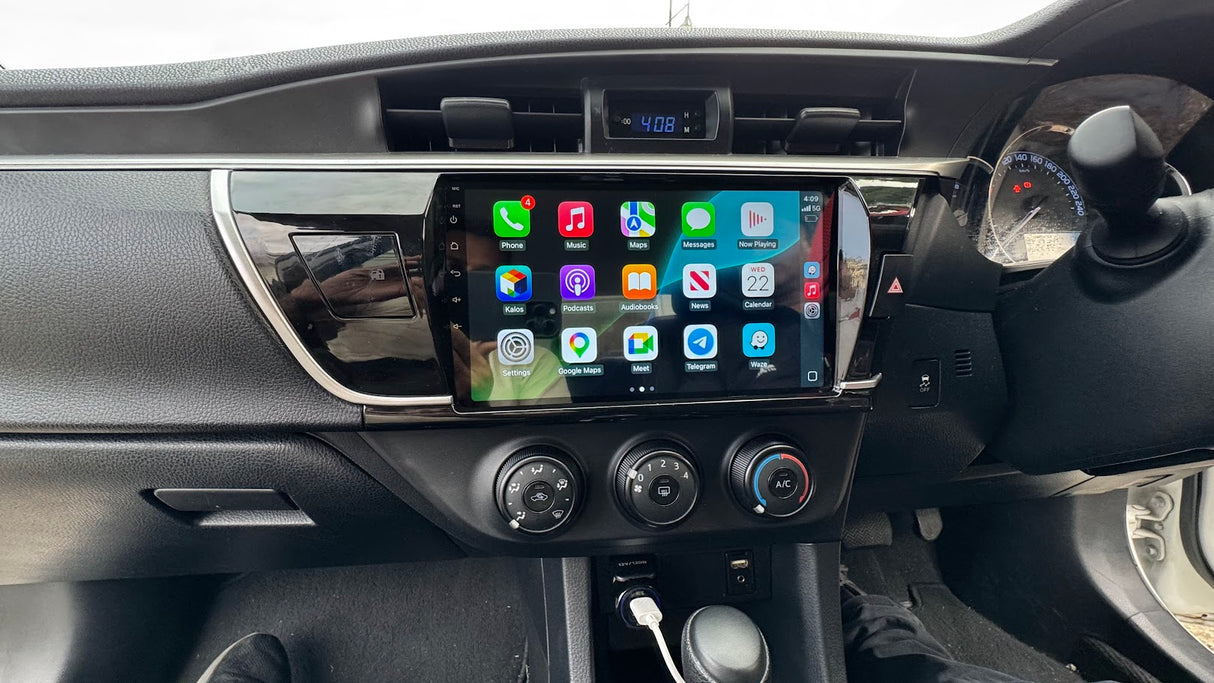 Corolla Sedan dashboard with a touchscreen display showing Carplay app icons.